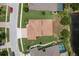 Aerial view of a home with a well-maintained lawn, landscaping, and proximity to a pond at 19123 Sunset Bay Dr, Land O Lakes, FL 34638