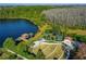 The aerial view shows the community park featuring a lake, playground, pier, and beautifully landscaped areas at 19123 Sunset Bay Dr, Land O Lakes, FL 34638