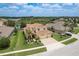 Beautiful two-story home with a three-car garage, green lawn, and mature landscaping situated on a quiet street at 19123 Sunset Bay Dr, Land O Lakes, FL 34638