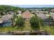 An aerial shot highlights the home's large backyard bordering a small lake and mature landscaping, offering privacy at 19123 Sunset Bay Dr, Land O Lakes, FL 34638