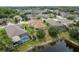 Aerial view of homes backing onto a pond, some with pools, in a landscaped community at 19123 Sunset Bay Dr, Land O Lakes, FL 34638