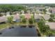 Aerial view of homes backing onto a pond; some homes feature private screened-in pools at 19123 Sunset Bay Dr, Land O Lakes, FL 34638