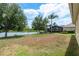 Large backyard with lush greenery, a serene pond, and mature trees creating a peaceful retreat at 19123 Sunset Bay Dr, Land O Lakes, FL 34638