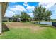 Expansive backyard with lush green grass, mature trees, and a serene pond view, perfect for outdoor relaxation at 19123 Sunset Bay Dr, Land O Lakes, FL 34638