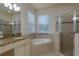 Bathroom featuring soaking tub, glass shower, granite countertops and decorative tile at 19123 Sunset Bay Dr, Land O Lakes, FL 34638