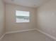 Bright, carpeted bedroom with a single window at 19123 Sunset Bay Dr, Land O Lakes, FL 34638