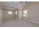 Spacious, carpeted bedroom featuring high ceilings and three windows at 19123 Sunset Bay Dr, Land O Lakes, FL 34638