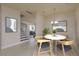 Bright dining area features a round table with chairs, modern lighting and stylish decor and stairwell access at 19123 Sunset Bay Dr, Land O Lakes, FL 34638