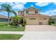 Charming two-story home boasts a well-manicured lawn, complemented by lush landscaping and a three-car garage at 19123 Sunset Bay Dr, Land O Lakes, FL 34638