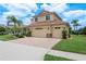 Charming two-story home boasts a well-manicured lawn, complemented by lush landscaping and a three-car garage at 19123 Sunset Bay Dr, Land O Lakes, FL 34638