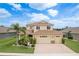 Beautiful two-story home with a well-manicured front yard and a three-car garage at 19123 Sunset Bay Dr, Land O Lakes, FL 34638