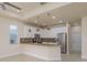 Open-concept kitchen with stainless appliances, granite countertops, bar seating, and casual dining area at 19123 Sunset Bay Dr, Land O Lakes, FL 34638