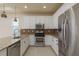 Well-appointed kitchen featuring granite countertops, stainless appliances, and tile floors at 19123 Sunset Bay Dr, Land O Lakes, FL 34638