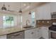 Bright kitchen with stainless appliances, granite countertops, and access to the lanai and lake views at 19123 Sunset Bay Dr, Land O Lakes, FL 34638