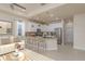 Open-concept kitchen with bar stool seating, pendant lighting, and stainless steel appliances for modern cooking at 19123 Sunset Bay Dr, Land O Lakes, FL 34638