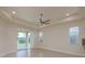 Bright living room with recessed lights, a ceiling fan, and sliding glass doors to the backyard at 19123 Sunset Bay Dr, Land O Lakes, FL 34638
