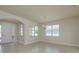 Bright and airy living room featuring neutral walls, tiled flooring, and an elegant chandelier at 19123 Sunset Bay Dr, Land O Lakes, FL 34638