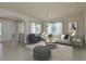 Bright living room features neutral decor, an area rug, and ample natural light through large windows at 19123 Sunset Bay Dr, Land O Lakes, FL 34638