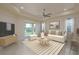 Comfortable living room features neutral tile flooring, access to outdoor space, and a ceiling fan at 19123 Sunset Bay Dr, Land O Lakes, FL 34638