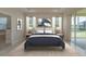 This spacious main bedroom features an ensuite bathroom, outdoor access, and plush carpeting at 19123 Sunset Bay Dr, Land O Lakes, FL 34638