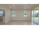 Bright main bedroom with tray ceiling, neutral color palette, and view of backyard at 19123 Sunset Bay Dr, Land O Lakes, FL 34638