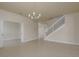 Open room with tile flooring, chandelier lighting, and an inviting view of the staircase to the upper level at 19123 Sunset Bay Dr, Land O Lakes, FL 34638