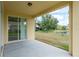 Covered patio providing a relaxing space with a view of the yard and pond at 19123 Sunset Bay Dr, Land O Lakes, FL 34638