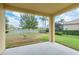 Covered patio overlooking the serene backyard with mature trees and peaceful pond views at 19123 Sunset Bay Dr, Land O Lakes, FL 34638