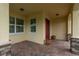 Charming covered entryway with tiled flooring and beautiful architectural details and stone columns at 19123 Sunset Bay Dr, Land O Lakes, FL 34638