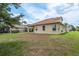 Rear view of the home showcasing a covered patio and spacious backyard at 19123 Sunset Bay Dr, Land O Lakes, FL 34638