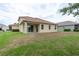 Back of house featuring a sliding glass door onto the patio and large back yard at 19123 Sunset Bay Dr, Land O Lakes, FL 34638