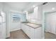 Bright kitchen with white cabinets, stainless steel appliances, and stone countertops under window at 19531 Gulf Blvd # 404, Indian Shores, FL 33785