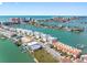Stunning aerial view showcases waterfront homes, docks, and the ocean skyline, offering luxurious coastal living at 200 Brightwater Dr # 10, Clearwater Beach, FL 33767