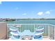 Balcony has chairs overlooking a beautiful waterfront view, creating a serene outdoor space for relaxation at 200 Brightwater Dr # 10, Clearwater Beach, FL 33767