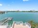 Scenic view from a balcony overlooking the waterfront with a private dock and city skyline at 200 Brightwater Dr # 10, Clearwater Beach, FL 33767