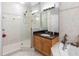This bathroom has a tile shower with a glass door, wood cabinets, and a soaking tub at 200 Brightwater Dr # 10, Clearwater Beach, FL 33767