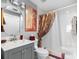 Bathroom features a modern vanity with a round mirror, toilet, and a shower with a decorative curtain at 200 Brightwater Dr # 10, Clearwater Beach, FL 33767