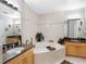 This bathroom has a large tub, dual sink vanities with granite countertops, and tile flooring at 200 Brightwater Dr # 10, Clearwater Beach, FL 33767