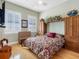 Cozy bedroom featuring hardwood floors, a comfortable bed, and natural lighting from the surrounding windows at 200 Brightwater Dr # 10, Clearwater Beach, FL 33767