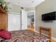 Well-lit bedroom features wood floors, a large closet, and a television, offering a comfortable space for relaxation at 200 Brightwater Dr # 10, Clearwater Beach, FL 33767