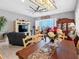 Open-concept dining area with water view and contemporary lighting at 200 Brightwater Dr # 10, Clearwater Beach, FL 33767