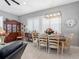 Dining room featuring plantation shutters, hardwood table, and wood accent furniture at 200 Brightwater Dr # 10, Clearwater Beach, FL 33767
