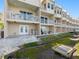 The back of this townhouse features multiple balconies, a patio, and access to the outdoors at 200 Brightwater Dr # 10, Clearwater Beach, FL 33767