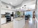 Open kitchen with stainless steel appliances, a kitchen island, and great waterfront views at 200 Brightwater Dr # 10, Clearwater Beach, FL 33767