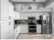 Modern kitchen with white cabinetry and stainless steel appliances at 200 Brightwater Dr # 10, Clearwater Beach, FL 33767