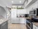 Bright kitchen featuring white cabinetry and stainless steel appliances at 200 Brightwater Dr # 10, Clearwater Beach, FL 33767