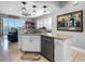 Kitchen with stainless steel dishwasher and sink overlooking the living area at 200 Brightwater Dr # 10, Clearwater Beach, FL 33767