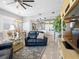 Open-concept living area with tiled floor, dining table, and view to kitchen at 200 Brightwater Dr # 10, Clearwater Beach, FL 33767