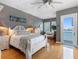 Bedroom with wood floors, large windows and a calming color scheme at 200 Brightwater Dr # 10, Clearwater Beach, FL 33767