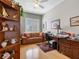 Comfortable office area featuring natural light, a ceiling fan, a desk, and a comfortable sofa for relaxing at 200 Brightwater Dr # 10, Clearwater Beach, FL 33767